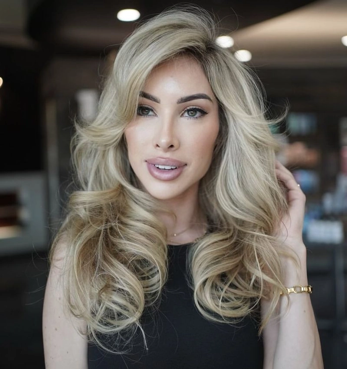 Voluminous blowout hairstyle for Latina date night Latina woman with voluminous blowout hairstyle for a date night look