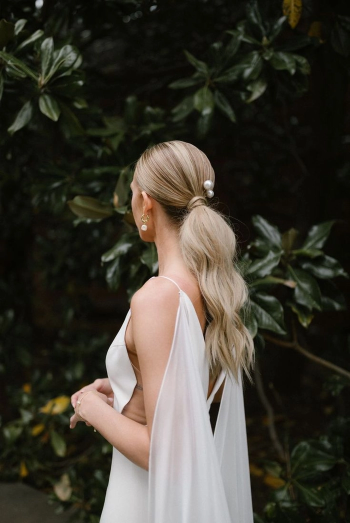 A woman with a long sleek ponytail, ready for an elegant dinner date