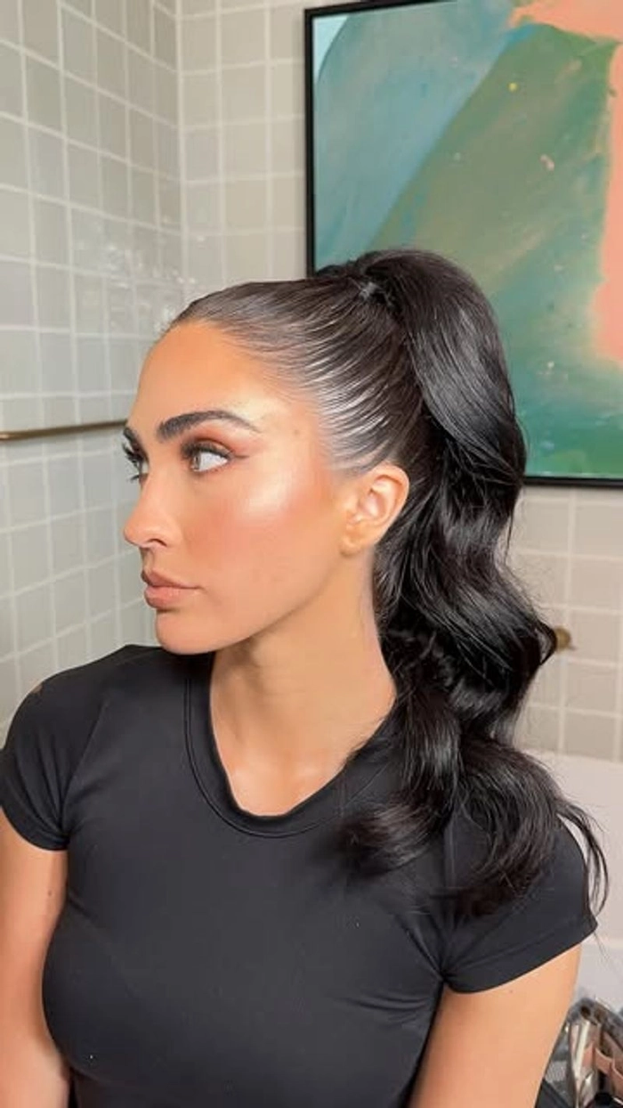 Elegant woman with a long sleek ponytail styled for a dinner date