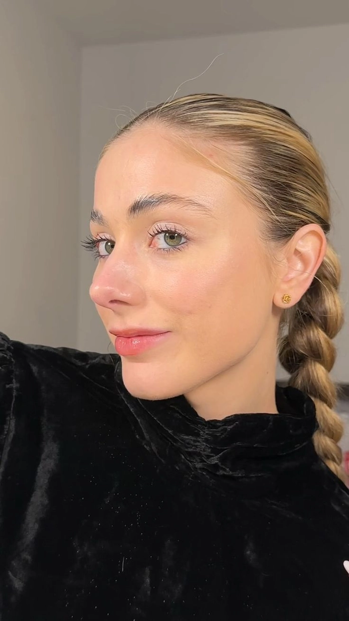 Clean and modern minimalist date night updo featuring a twisted low bun with delicate wispy pieces Effortless millennial minimalist updo with sleek twisted bun and soft face-framing strands for a date night