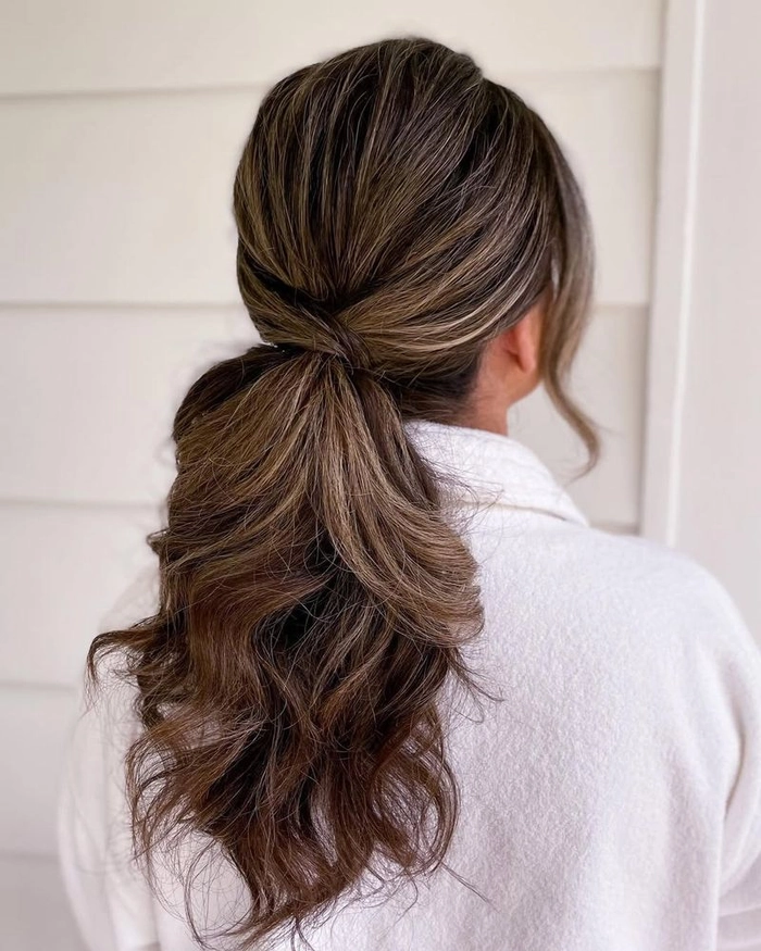 Low Ponytail Winter Evening Date Hair Style Polished low ponytail hairstyle for a winter evening date night