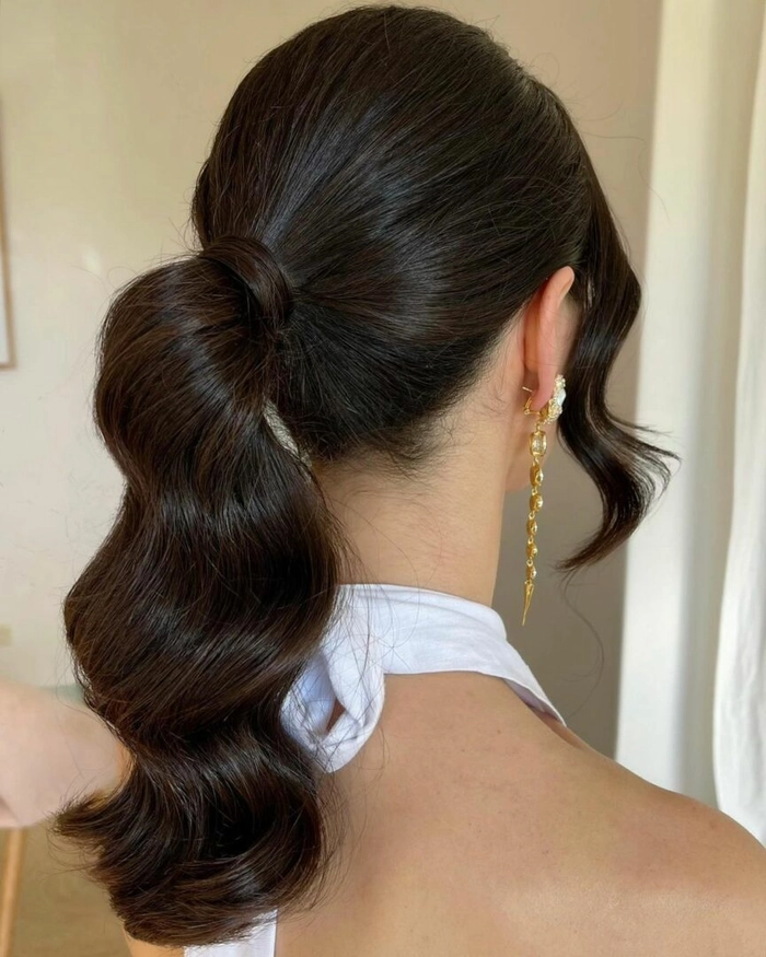 Elegant low ponytail with smooth finish, perfect for winter date nights Polished low ponytail for winter evenings, elegant date night hairstyle