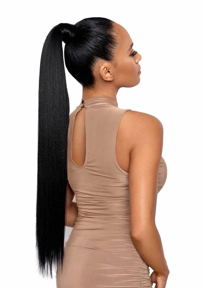 A woman wearing a long sleek ponytail with elegant makeup, dressed for a romantic dinner date
