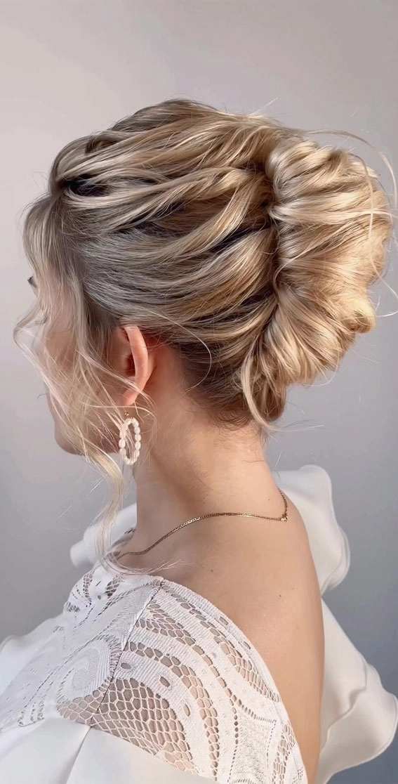 Elegant French twist with delicate curls perfect for a romantic formal date night Romantic French twist hairstyle for a formal date, with elegant curls and soft face-framing strands