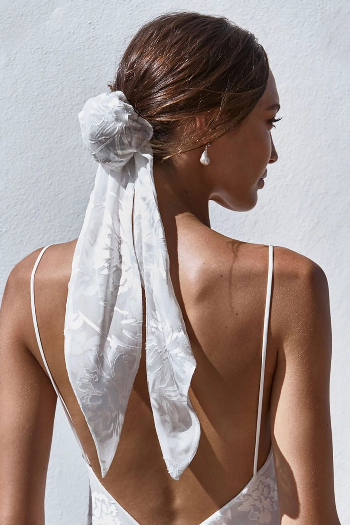 Romantic date night hairstyle featuring a delicate lace hair accessory