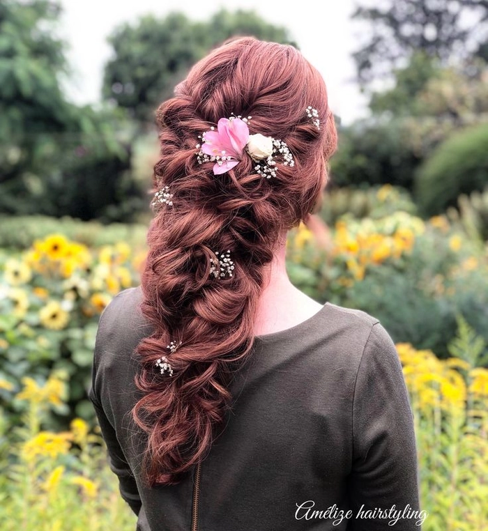 Romantic updo hairstyle featuring fresh flowers for a special evening Elegant romantic updo adorned with fresh flowers for a date night look