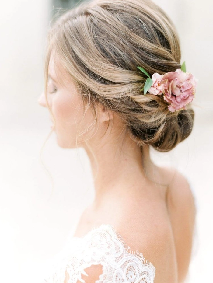 Romantic date night hairstyle featuring fresh flowers in an elegant updo Romantic updo with fresh flowers for a date night look