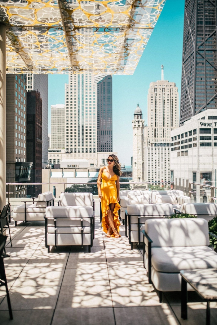 Wind-resistant hairstyles for a romantic rooftop bar date night Couple enjoying a rooftop bar date night with wind-resistant hairstyles
