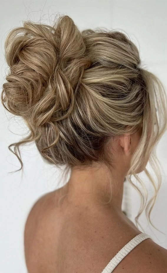 Casual date night hairstyle featuring a soft shoulder-length messy bun Woman with a shoulder-length messy bun hairstyle perfect for a casual date night