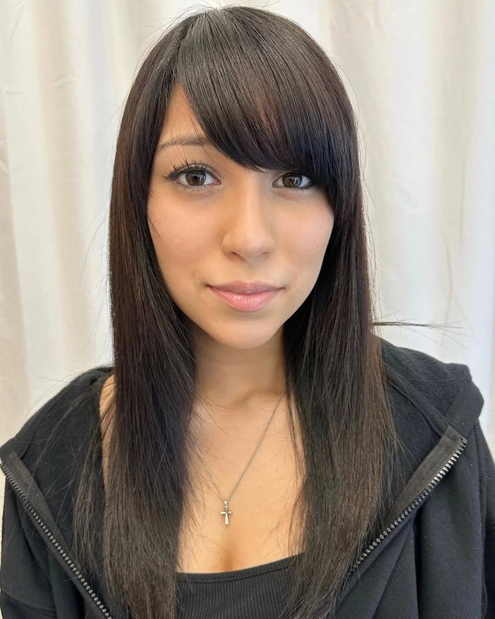 Elegant date night hairstyle with side swept bangs and soft waves