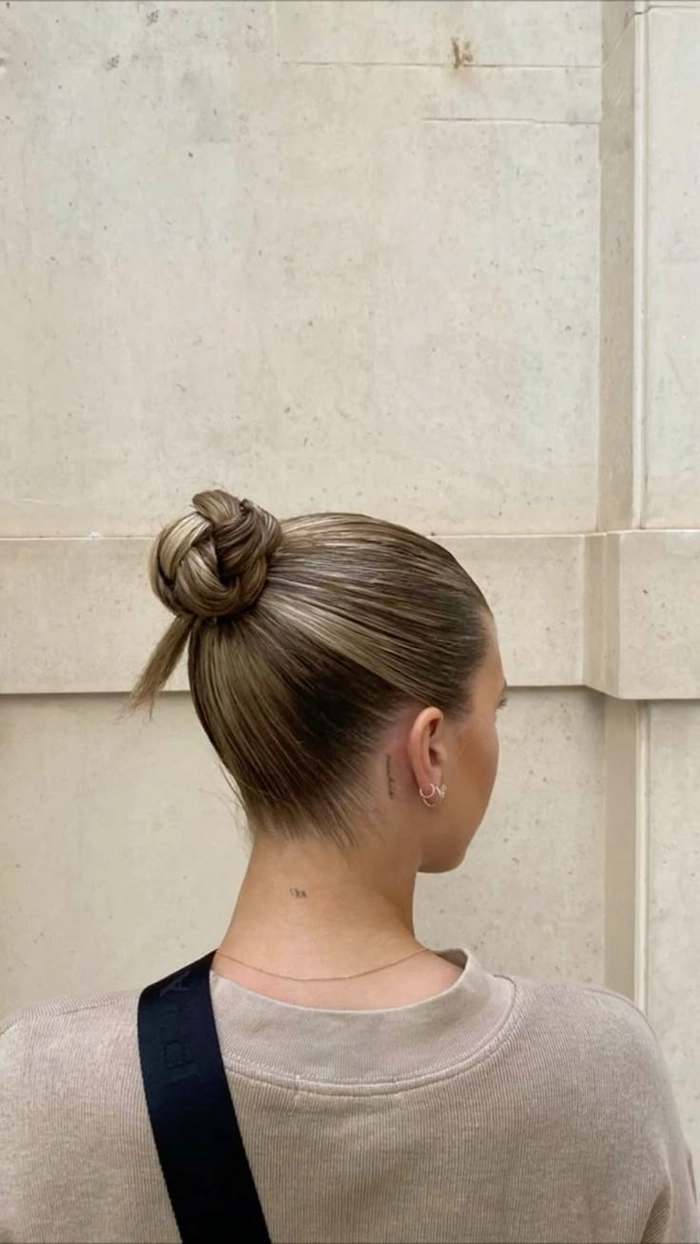 Elegant date night hair with silk ribbon wrapped buns Sleek buns tied with silk ribbons for a date night hairstyle