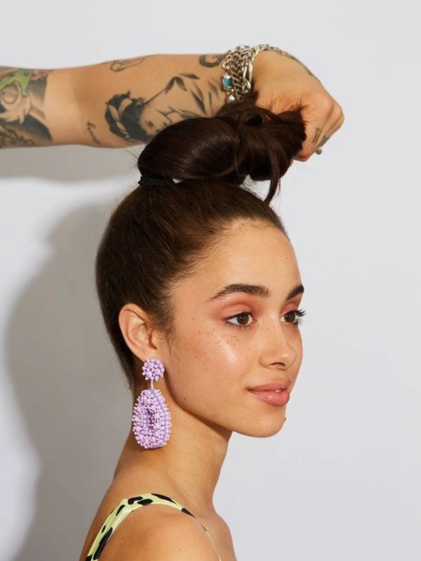 Sleek buns adorned with silk ribbons, perfect for an elegant evening hairstyle Sleek buns wrapped with luxurious silk ribbons for a romantic date night look