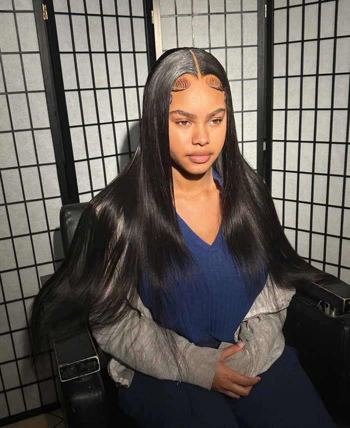 Sleek straight hair with middle part perfect for a romantic dinner outing Elegant sleek middle part straight hair styled for a dinner date