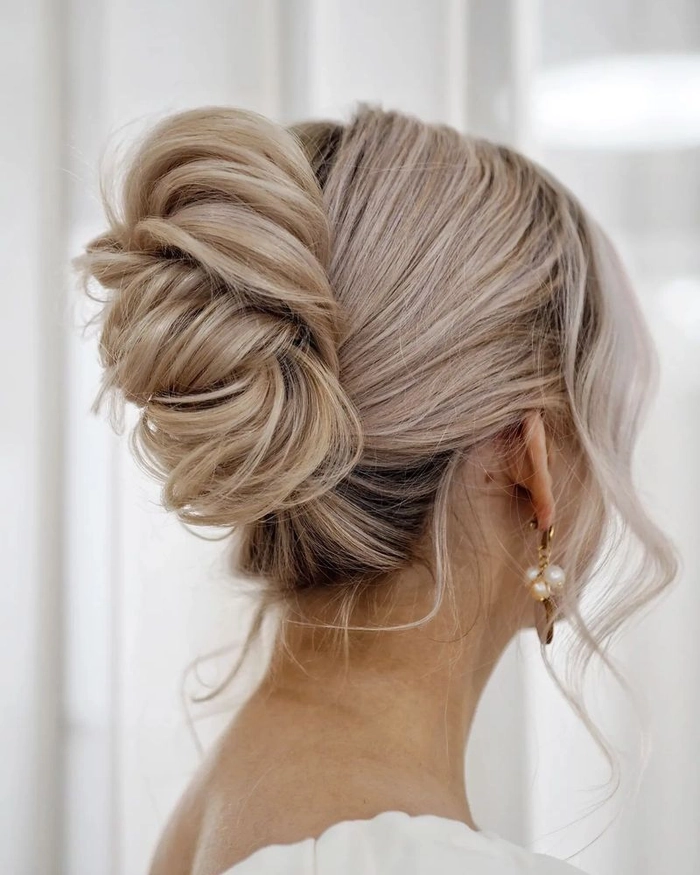 Sleek and polished top knot perfect for formal evening occasions Elegant top knot hairstyle for a sophisticated evening event date night