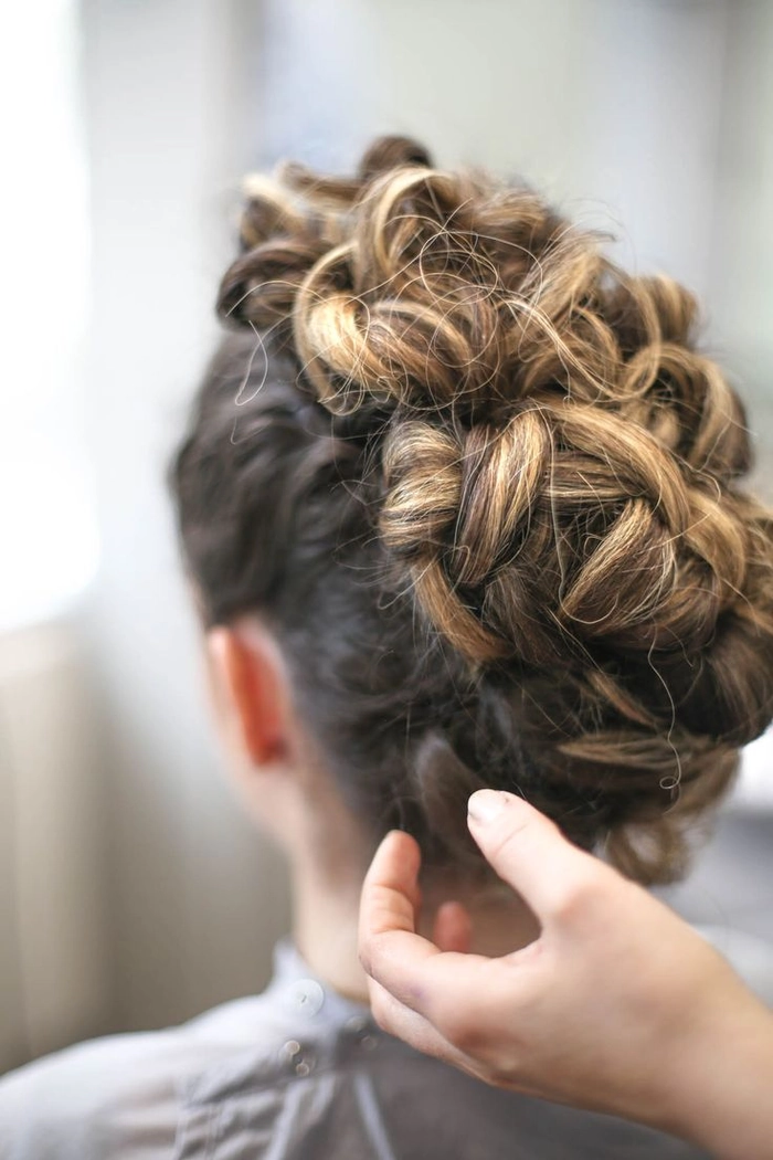 View of a sleek and polished sophisticated top knot for evening wear Sophisticated top knot hairstyle styled for an evening date night event