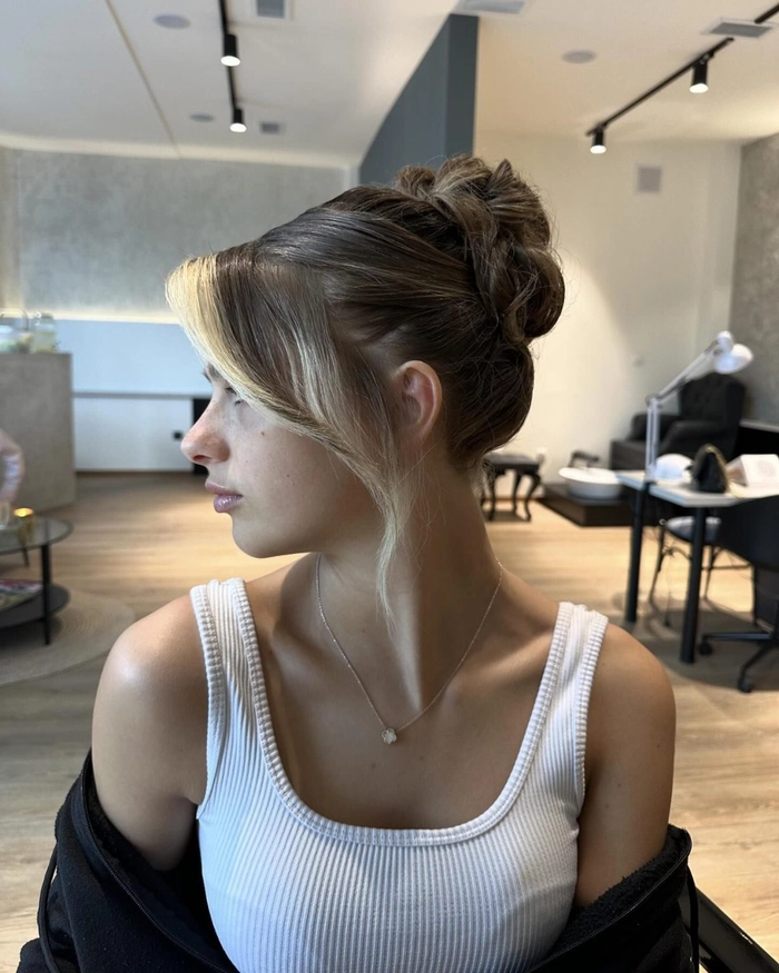 A stylish straight hair elegant bun for a date night look, featuring smooth strands and a polished finish.