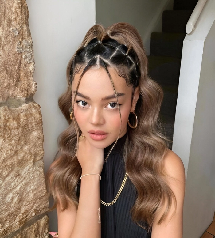 Summer outdoor concert date hair with loose waves and floral accent A woman with soft beachy waves and a floral hair clip for a summer concert date hairstyle