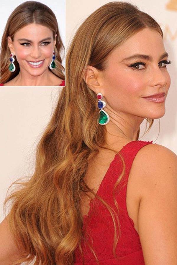 A woman with thick hair styled in an effortless evening updo for a date night