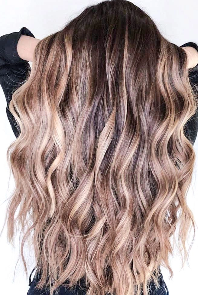 Tousled beach waves for summer date night hairstyle A woman with tousled beach waves hairstyle perfect for a summer date night