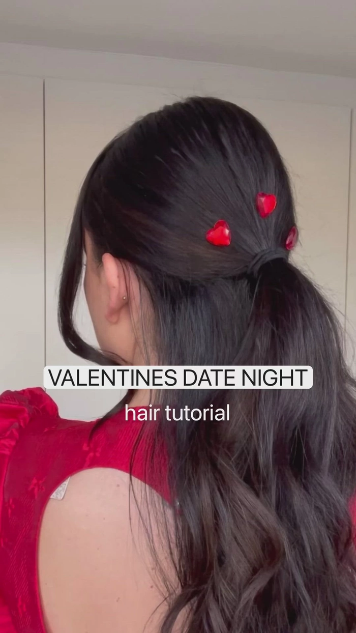 Woman styling her hair into a quick, travel-friendly updo for a date night