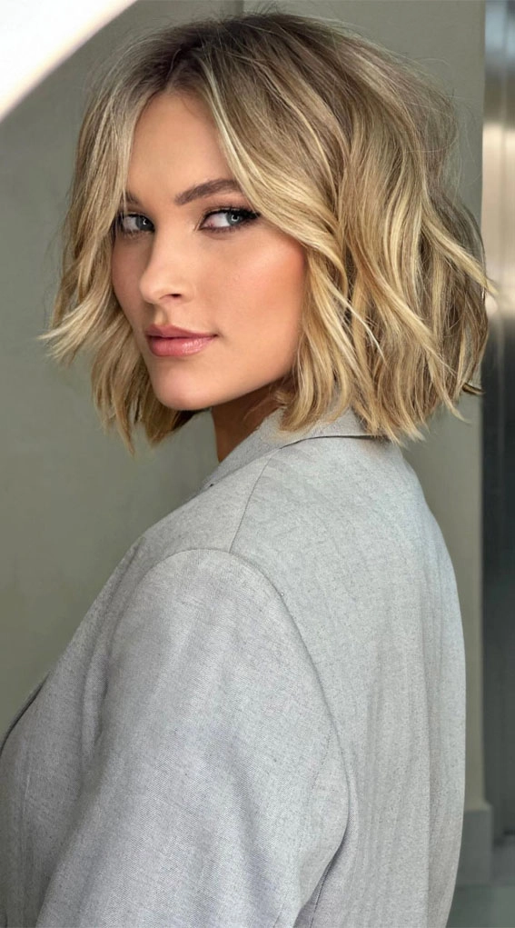 A woman with a wavy bob hairstyle smiling on a first date
