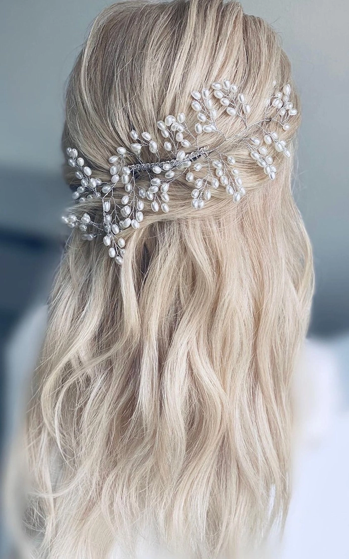 Chic updo with icy crystal pins perfect for a cozy snowy evening out Elegant winter wonderland hairstyle with delicate glittering accessories for a romantic date night