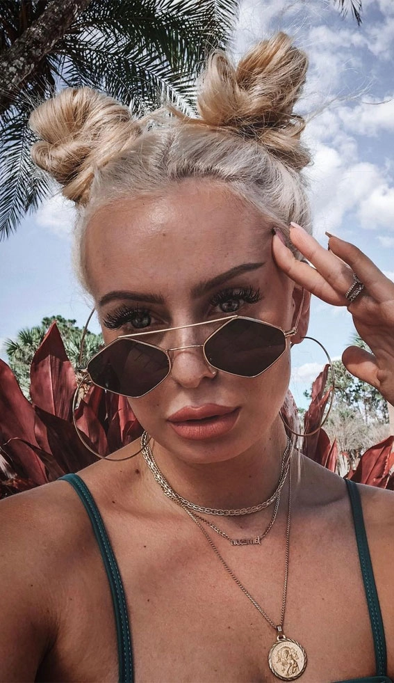 Beach festival hairstyles for women with braids and floral accessories