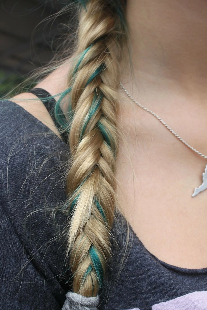 Colorful braided festival hairstyle perfect for Bonnaroo Bonnaroo festival hairstyle with braided accents and floral accessories