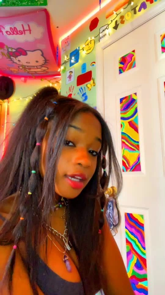 Bonnaroo festival hairstyle with vibrant braids and flowers Woman with colorful braids and floral crown at Bonnaroo music festival