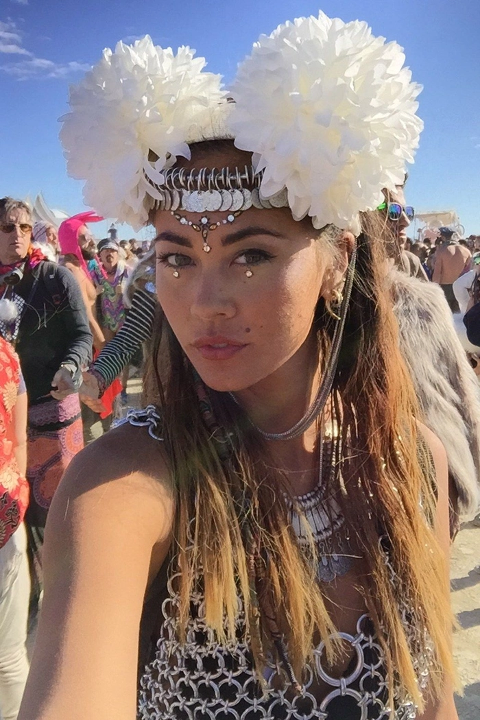 Festival hairstyle inspiration for Burning Man with braids and beads Burning Man hairstyle with braids, feathers, and vibrant hair wraps