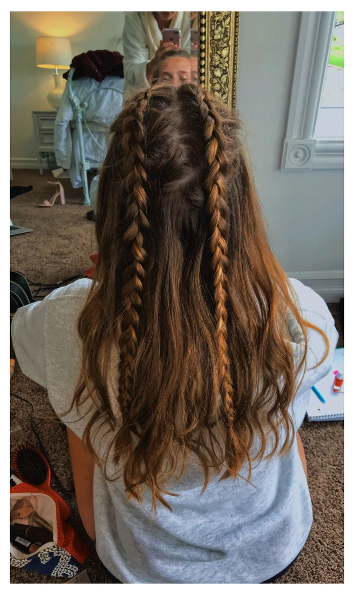 Messy braided updo for camping festivals with floral accents