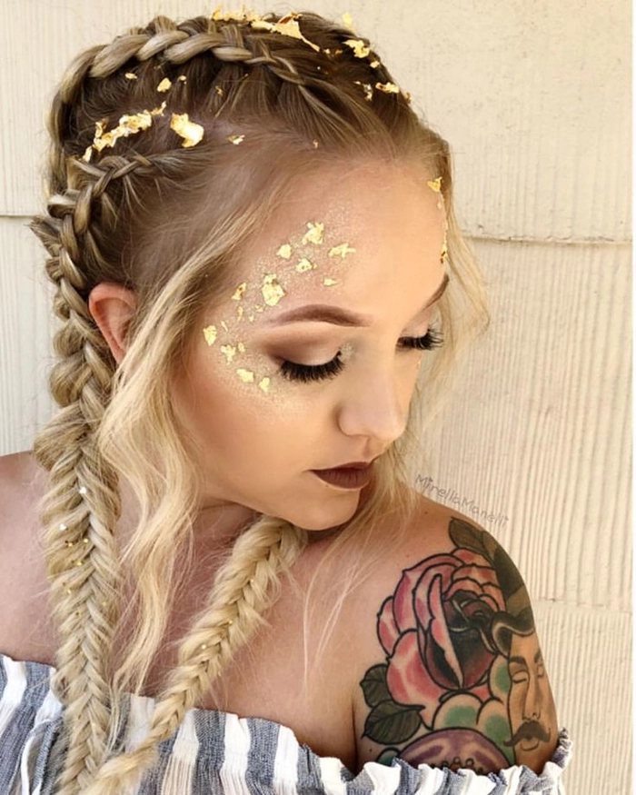 A woman with braided updo and floral hair accessories at a festival.