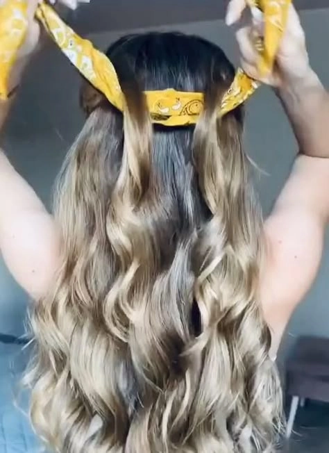 Country music festival hairstyle inspiration with braided crown and soft waves Women with braided crown and loose waves at a country music festival