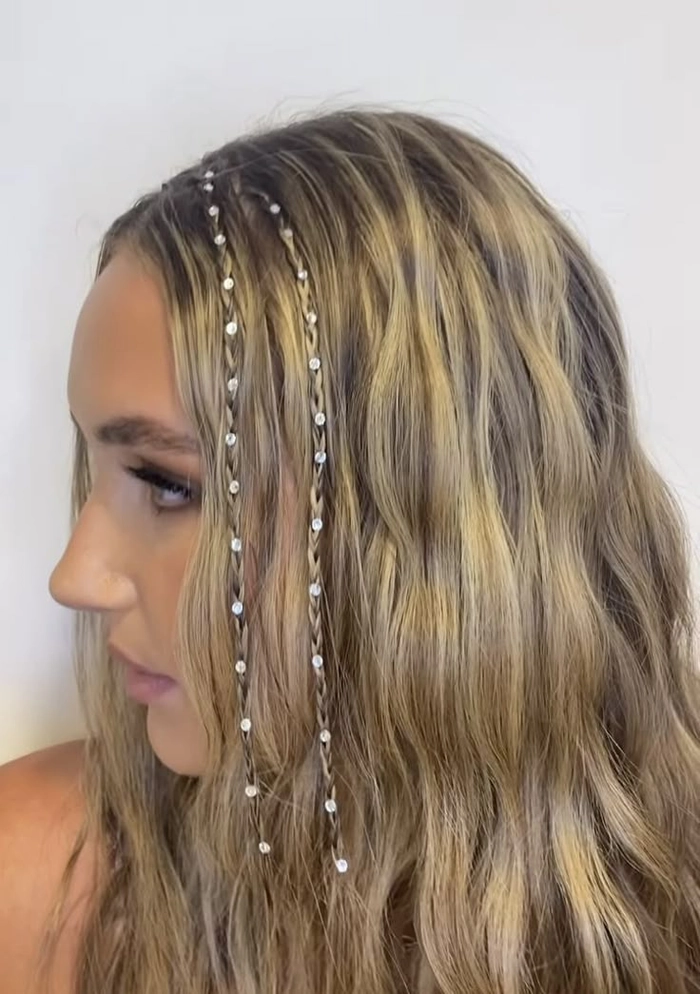 Country music festival hairstyle idea: braided updo with wide-brim hat Woman with a braided crown and cowboy hat at a country music festival