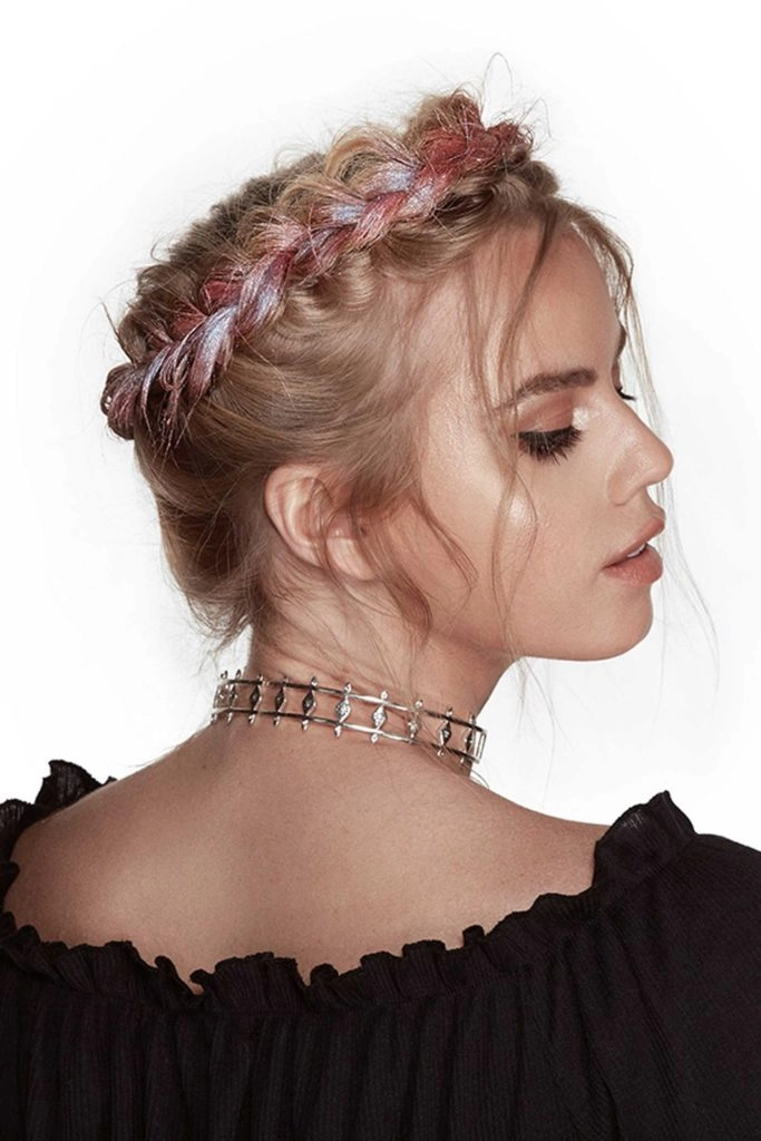 A daytime festival look with a half-up braided style and woven ribbon accents.