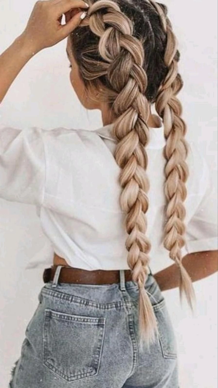 Woman with festival Dutch braid hairstyle adorned with floral clips and glitter