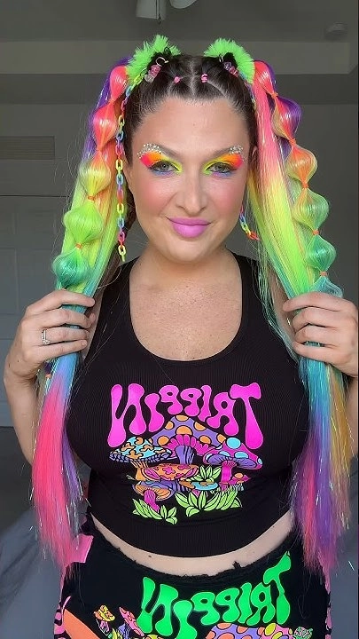 Edgy braided updo with neon hair extensions for an EDM festival look