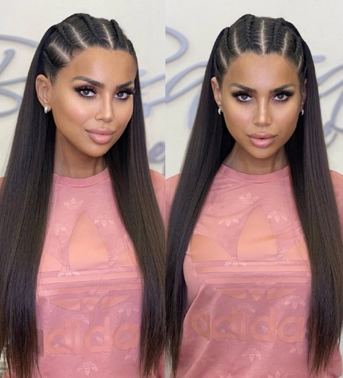 A woman with an elegant braided updo and floral accents for a festival look