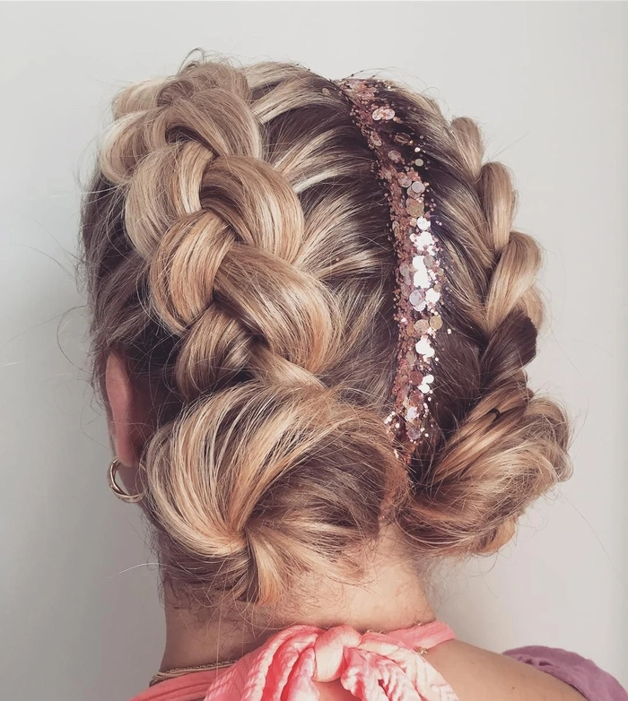 Festival braided hairstyle with colorful hair rings and flowers for a boho look