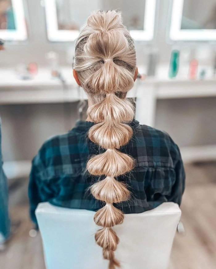 Edgy festival bubble braid hairstyle with colorful extensions and beads