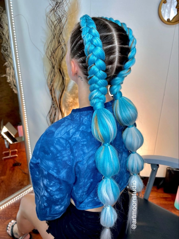 Festival bubble braid hairstyle with colorful accessories