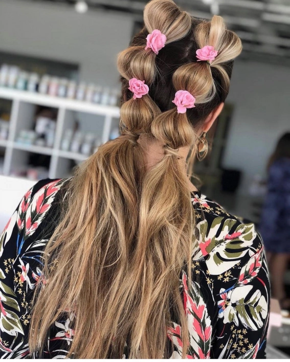 Girl wearing a festive bubble braid hairstyle with vibrant hair ties