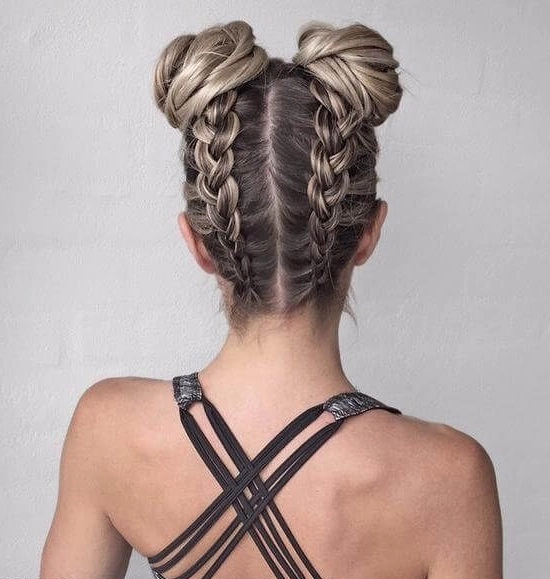 A festival-goer with a stylish messy bun decorated with flowers and ribbons