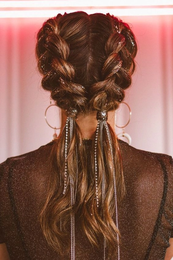 Festival bun hairstyle with braided accents and floral accessories