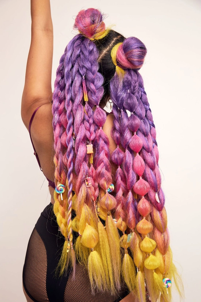 Festival bun hairstyle with braided crown and colorful accessories