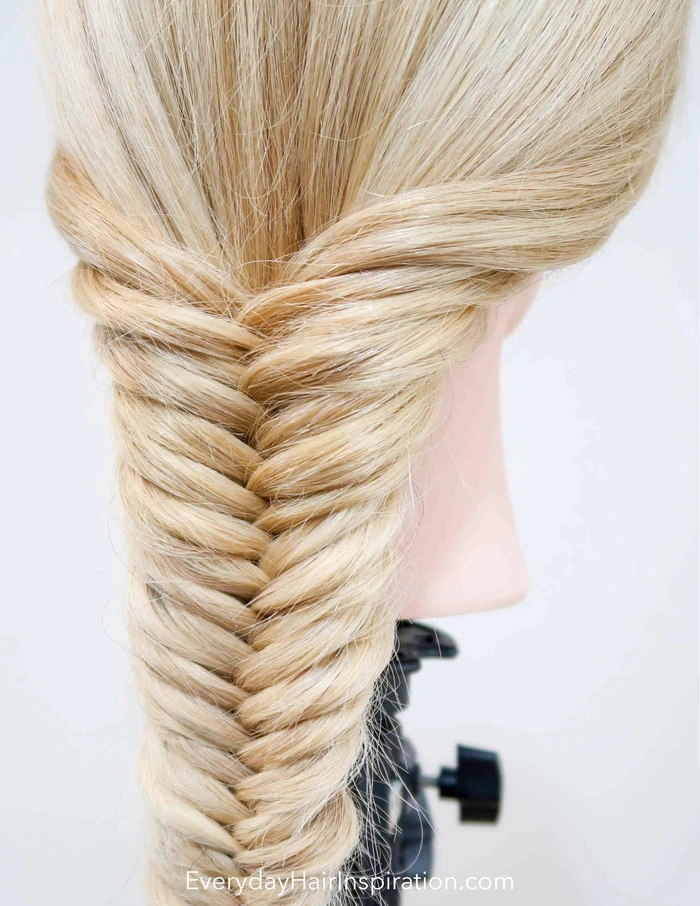 Festival fishtail braid hairstyle with vibrant hair accessories