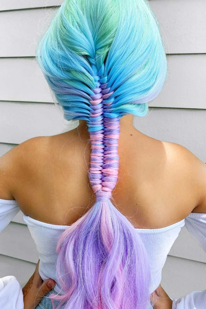 Festival fishtail braid hairstyle with bohemian waves and floral accents for a boho chic look