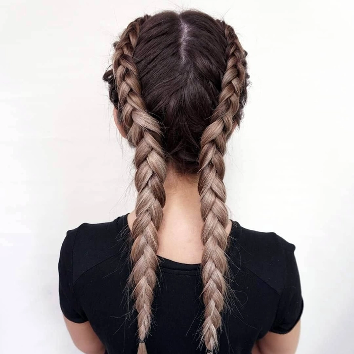 Festival-ready French braid hairstyle with flowers woven throughout