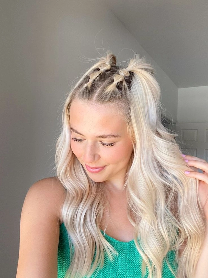 Boho festival look with side-swept bangs and delicate flower clips Festival hairstyle with bangs, braided crown and vibrant hair accessories