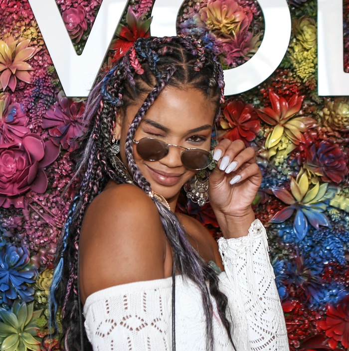 Boho braided updo with colorful bead accents for festival Vibrant festival hairstyle with twisted braids and shiny beads